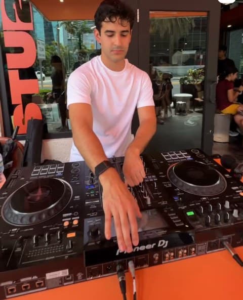 A member DJing on Pioneer decks